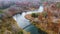 Aerial right over Michigan river with suspension bridge and fall colors