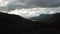 Aerial Rising Through Dramatic Scottish Landscape To Reveal Loch Nestled In Mountains