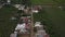 Aerial Rising Over Poor Caribbean Village Motorcycle On Road