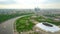 Aerial rising shot of Moscow cityscape involving Luzhniki football stadium and distant business center skyscrapes