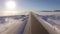 Aerial roadways. Suv driving in white snowy evergreen forest on slippery asphalt road. Aerial view of the road and the