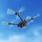 Aerial robot drone, quadrocopter, with camera flying in the blue sky. Concept hovering multycopter render