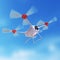 Aerial robot drone, quadrocopter, with camera flying in the blue sky. Concept hovering multycopter render