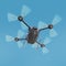 Aerial robot drone, quadrocopter, with camera flying in the blue sky. Concept hovering multycopter render