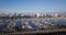 Aerial rotate right of shoreline yachts docked on blue water near long beach