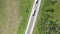 Aerial rotatining view of a fast trucks on the road in countryside