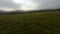 Aerial rotation panorama view woman in warm plaid running surrounded by foggy natural valley