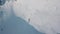 Aerial rotation shot male sport man with snowboard standing surrounded by white clear snow