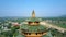 Aerial round close motion Buddhist pagoda roofs against valley