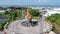 Aerial roundabout with fish statue with barong head in Pelabuhan Benoa harbor in Bali