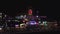 AERIAL: Santa Monica Pier at night with Ferris Wheel and colorful lights,