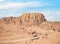 Aerial scene from the ancient city of Petra, Jordan. View of the Colonnaded Street and a massive rock red mountain in the