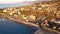 Aerial scene of sunny Puerto de Bordighera coast houses by the sea with boats in Imperia, Italy
