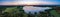 Aerial Scenic panorama of midnight Sun in Northern Sweden, middle summer light nights, polar region. Red orange sky, blue lake,