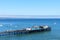 Aerial scenic view of Capitola Wharf at calm ocean waters of Monterey Bay on sunny summer day - Capitola, California, USA - July,