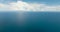 Aerial Seascape: Blue sea and sky with clouds.