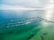 Aerial seascape of moored boats in marina and beautiful turquoise bay waters at sunrise.