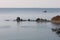 Aerial seascape of Peter The Great Bay in sunny autumn day in sunrise. Calm blue water, rocky capes and islands with lighthouse, s