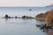 Aerial seascape of Peter The Great Bay in sunny autumn day in sunrise. Calm blue water, rocky capes and islands with lighthouse, s