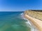 Aerial seascape, of Praia Porto de Mos Beach and seaside cliff formations along coastline of Lagos city, Portugal.