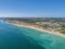 Aerial seascape, of Praia Porto de Mos Beach and seaside cliff formations along coastline of Lagos city, Portugal.