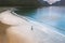 Aerial seaside view woman walking with child on sandy beach family vacation