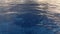 Aerial of serene blue sea waves under sunlight