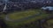 Aerial shoot of cyclists cycling round track outdoors in park, Glasgow Scotland