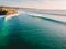 Aerial shooting of big waves at sunset. Biggest ocean waves in Bali and coastline