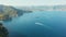 Aerial shooting of a sea with blue water and sailing motor boats. Ligurian sea surrounded by mountains.