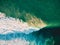 Aerial shooting of surfing at sunset. Surfers and ocean wave