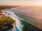 Aerial shooting of waves in ocean and shore at sunset