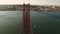 Aerial shot of The 25 de Abril Bridge crossing Tagus River