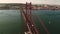 Aerial shot of The 25 de Abril Bridge crossing Tagus River