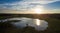 Aerial shot at 40 metres of a lake sunset