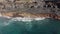 Aerial shot. Abandoned stone buildings of ancient people on the volcanic coast of the island. The landscape is big