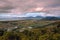 Aerial shot of  an agricultural valley under a pink cloudy sky