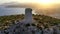 Aerial shot of an ancient tower by the sea