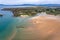 Aerial shot of the Atlantic ocean meeting the sandy shores of the County Donegal in Ireland on