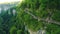 aerial shot of an awesome nature - high cliffs with bright green vegetation and a hiking trail on it