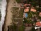 Aerial shot of a beach taken from the coast where the waves of the sea are reaching a beautiful neighborhood full of vegetation