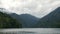 Aerial shot of beautiful alpine lake Ritsa speed boat floating summer, View from Above on Gorgeous Lake Ritsa between