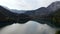 Aerial shot of beautiful alpine lake Ritsa speed boat floating summer, view from above on Gorgeous Lake Ritsa between