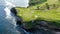 Aerial shot of beautiful golf course on overgrown rocky cliff top in sunny luxury tourist resort on paradise island Bali