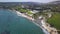 Aerial shot of beautiful seashore with black sand beach, white cliffs and resort area