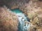 Aerial shot of beautiful Sluncica river wll, hidden deep in the  mountain forest with stone cascades in the river stream