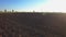 Aerial shot of black plowed field in spring