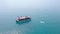 Aerial shot blue sea lagoon with sailing ship and swimming people. Drone view people bathing around boat sailing in