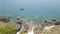 Aerial shot blue sea with sailing ship and mountain cliff on coastline. Beautiful landscape boat sailing in turquoise