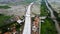 Aerial Shot. Bridge under construction and The edge of an urban river with houses